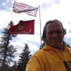 Cowboy hat person with American flags and nature background