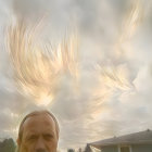 Surreal image: small helmet on person's head with massive sculpted face