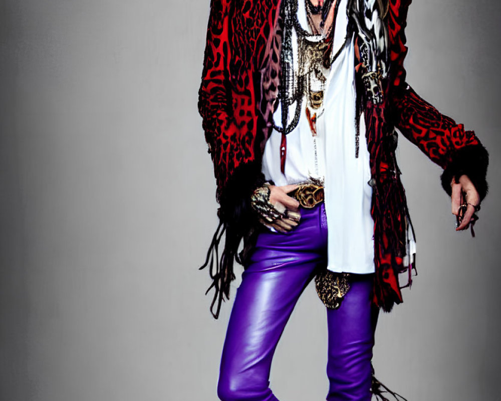 Colorful Outfit with Purple Pants and Red Jacket on Grey Background