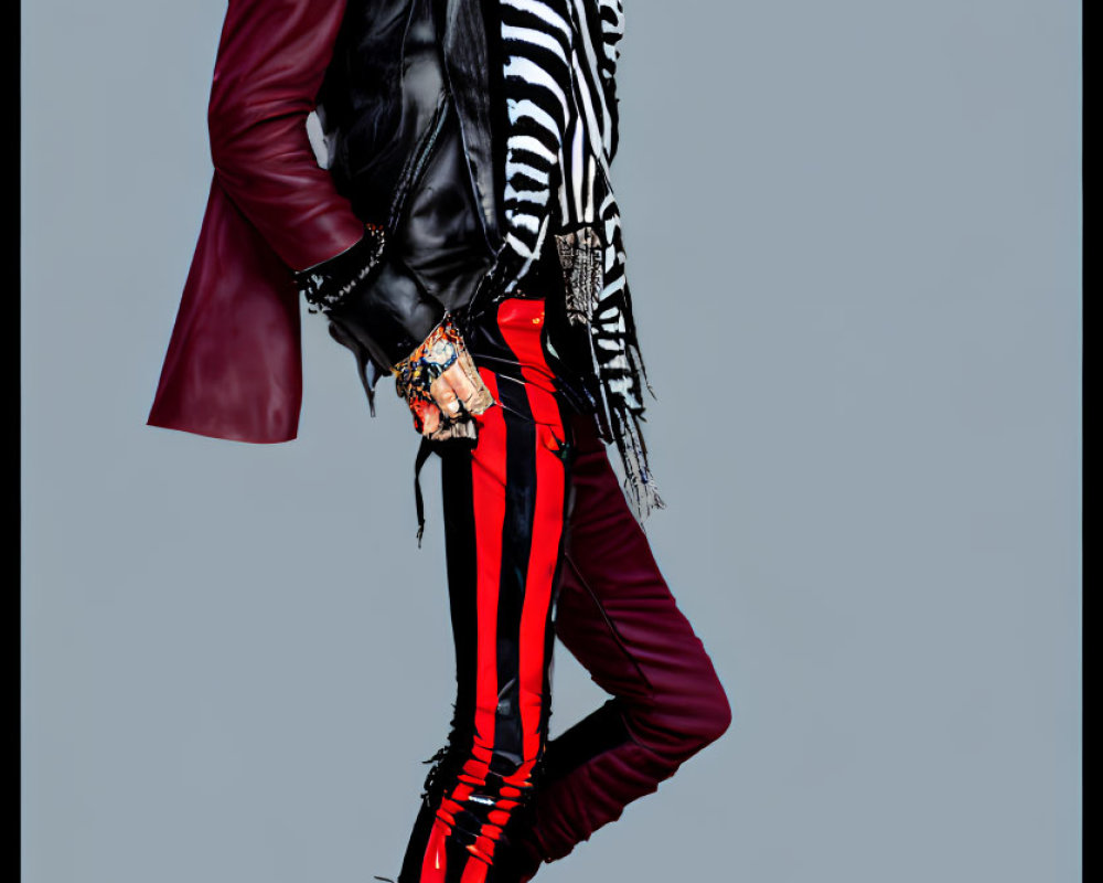 Fashionable outfit with burgundy jacket, striped shirt, and fringe boots