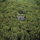 Moss-Covered Castle in Mystical Forest with Serene Water