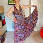 Colorful mosaic-patterned dress on woman in vibrant room