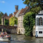 Lush riverside landscape with traditional houses and boats