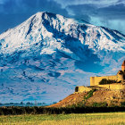 Snow-capped mountain and castle-like structure under dramatic sky