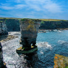 Scenic lighthouse on rugged cliff by turbulent sea