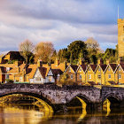 Illustration of quaint village with autumnal trees, castle, stone bridge