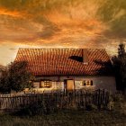 Sunset scene with lightning strikes over quaint house