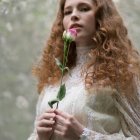 Woman Holding Pink Rose in Realistic Painterly Style