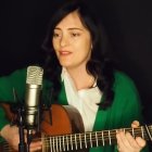 Digital artwork: Young girl with blue eyes & black hair, green blouse, playing lute