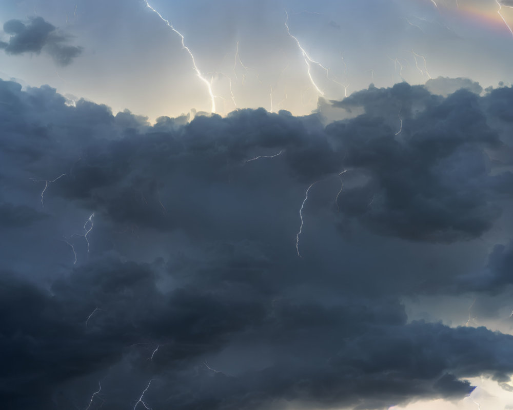 Stormy Sky with Faint Rainbow and Lightning Strikes