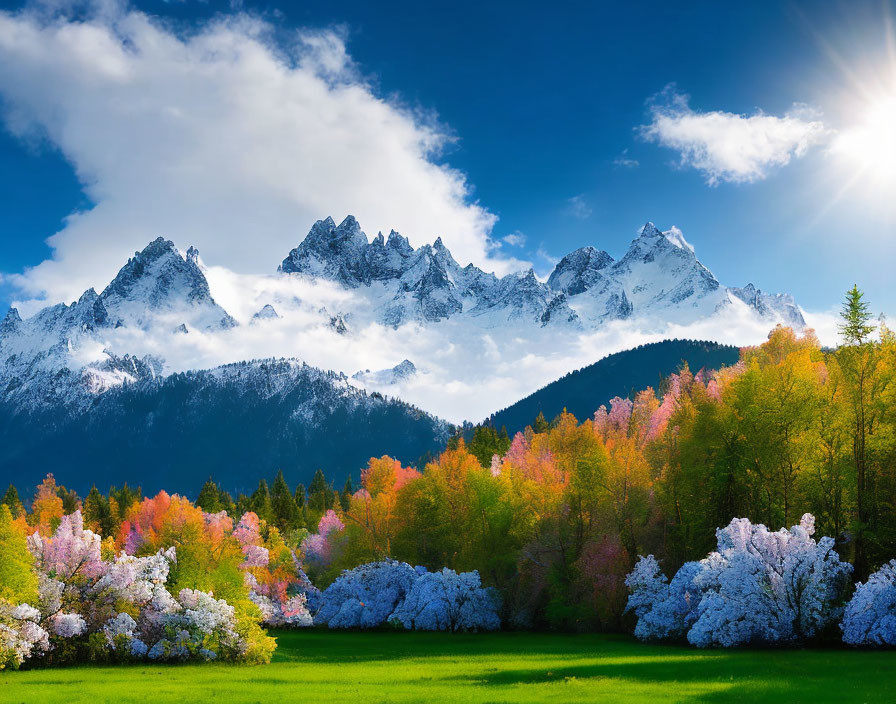 Snow-capped peaks and autumn trees under blue sky.