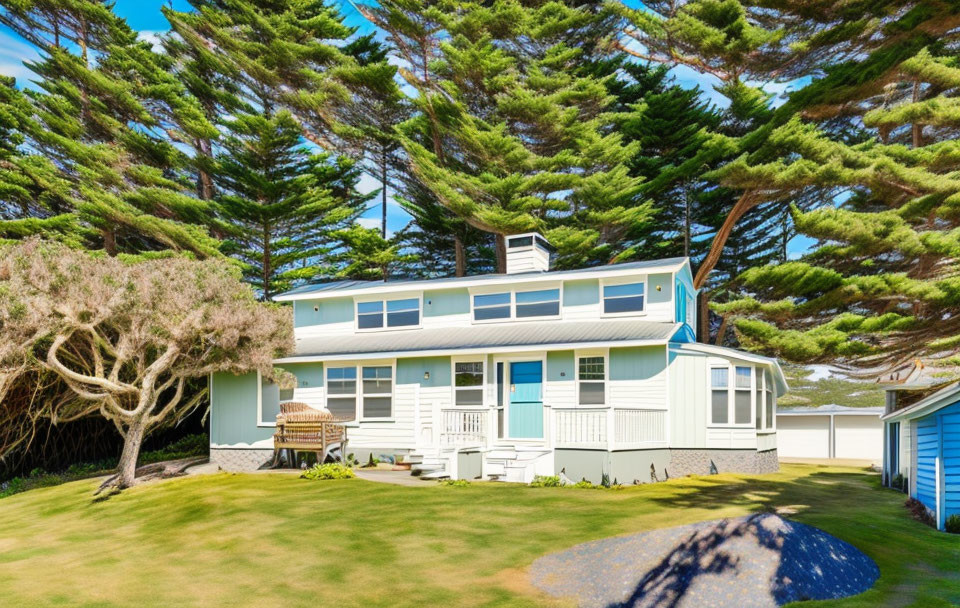 Coastal cottage with white siding and blue trim in lush surroundings