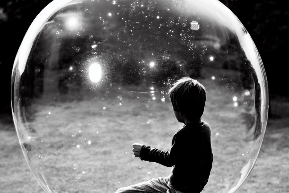 Child mesmerized by large soap bubble in sunlit park