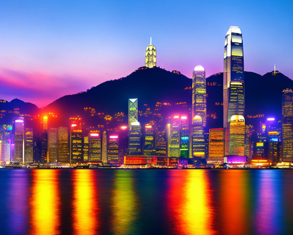 Modern city skyline at twilight with illuminated skyscrapers against a purple sky reflected on water.