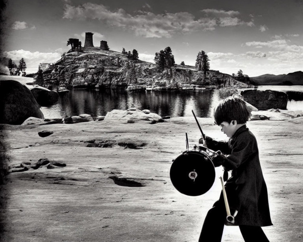 Monochrome image of boy playing drum by serene lake