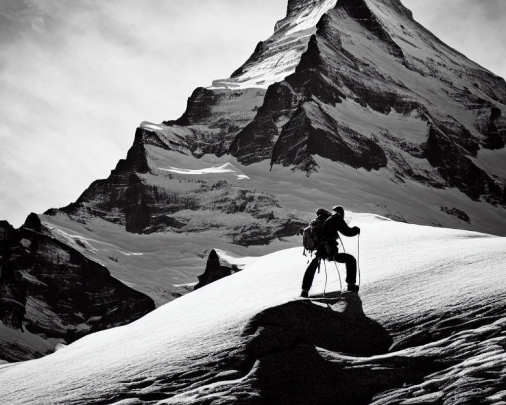 Monochrome image of person trekking snowy mountain landscape