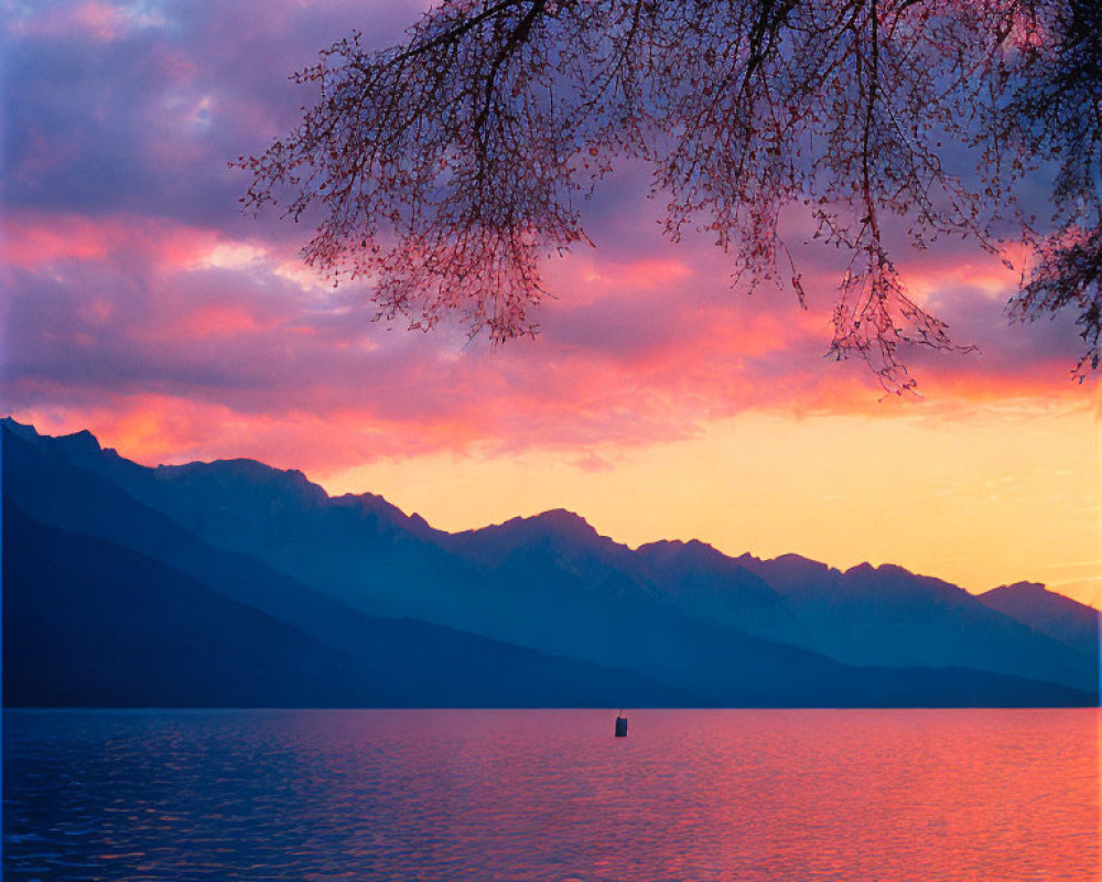 Tranquil sunset lake scene with pink and blue skies, silhouetted mountains, lone boat