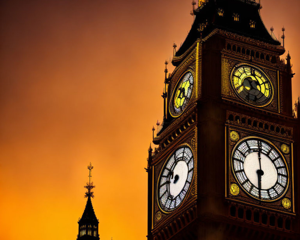 Clock tower silhouette against fiery orange sky with illuminated clocks.