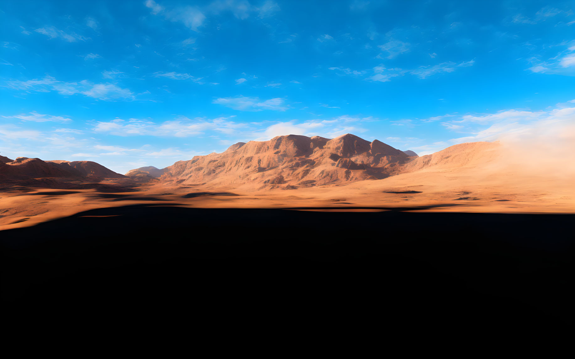 Desert landscape with mountains, blue skies, and sand dunes.