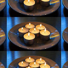 Colorful Plate Pattern with Lit Candles & Confetti on Dark Background