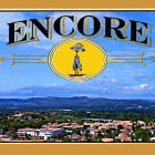 Colorful "ENCORE" poster: Airship, landscapes, mountains, hot air balloons under blue