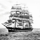 Black and white clipper ship sailing on rippling sea with distant ships and cloudy sky