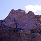 Vibrant desert landscape with purple flora and red sandstone spires