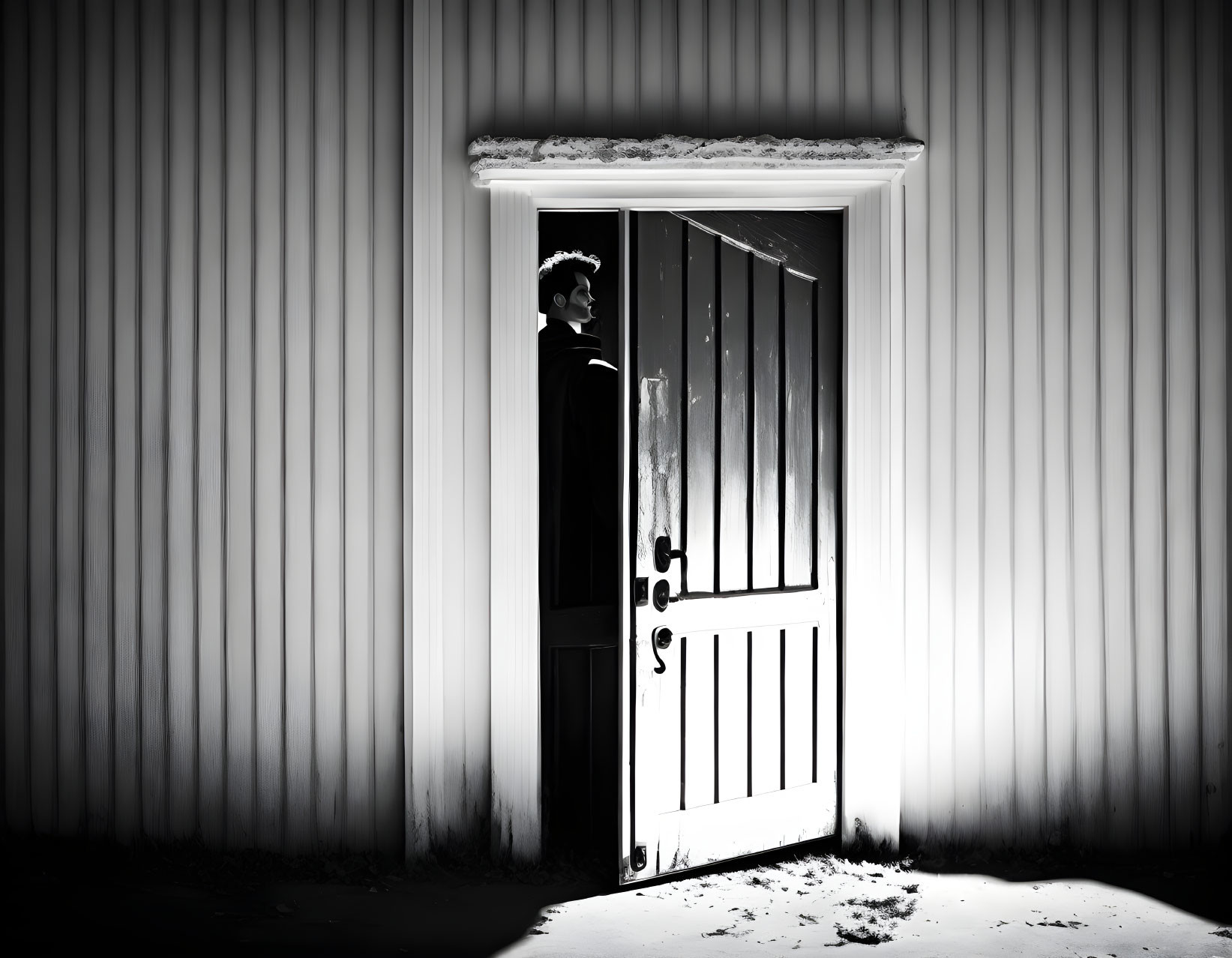 Person in Doorway of Building with Corrugated Walls in Stark Light and Shadow