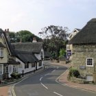 Historical figure walking in picturesque village at dusk