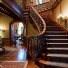 Elegant staircase with wooden banisters, blooming flowers, lamps, and sunlight.