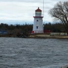 Serene lighthouse on rugged coastline with crashing waves