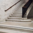 Luxurious interior featuring elegant white marble staircase with intricate patterns