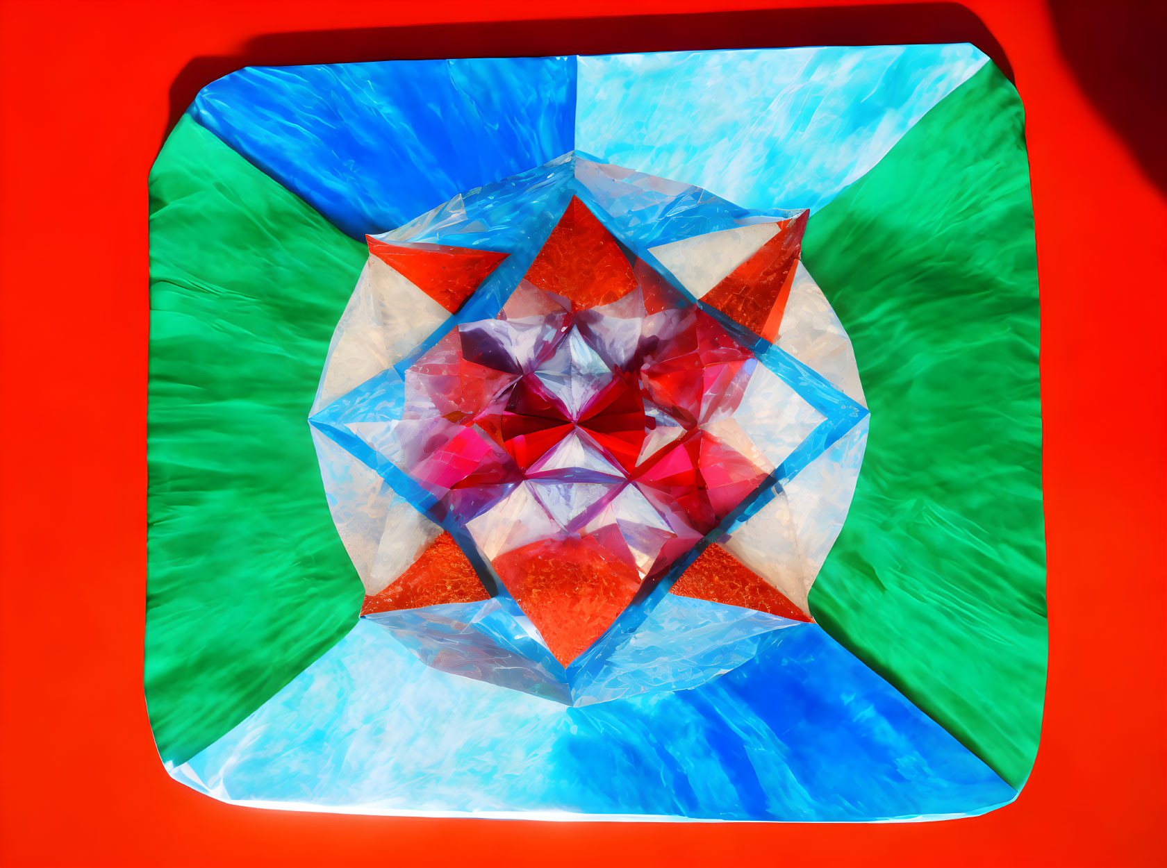 Vibrant Kaleidoscopic Star Pattern in Red, Blue, and Green