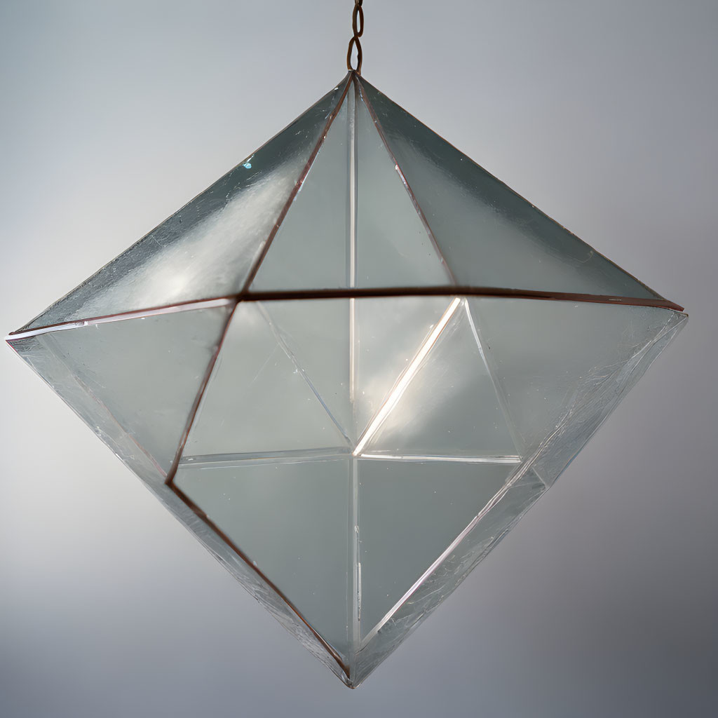 Geometric Glass Pendant Light with Soft Reflection on Neutral Background