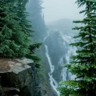 Lush Mountain Landscape with Waterfalls and Misty Peaks