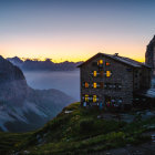 House on Mountain Edge at Dusk with Reflective Lake