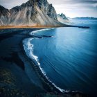 Vivid art: Sand dunes, mountain, sunset sky, wispy clouds