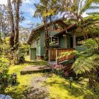 Rustic wooden house in lush greenery under sunny sky