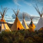 Vibrant Teepees Painting with Mountain and Flower Landscape