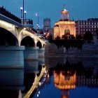 Cityscape illustration: Night scene with bridge, river reflections, and starry sky