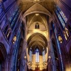 Modern Cathedral Interior with Soaring Arches and Stained Glass Windows