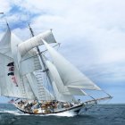 Sailing ship with American flag in rough sea waters