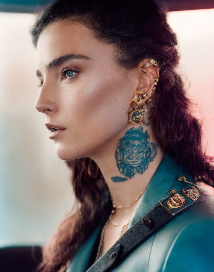 Woman with ornate earrings and lion tattoo gazes away with braided brown hair