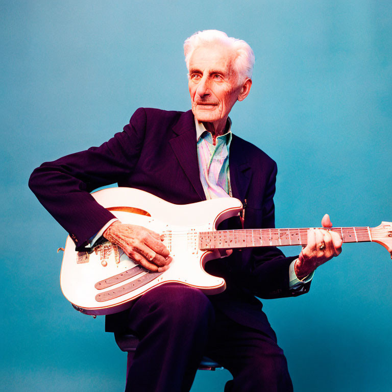 Grey-Haired Elderly Man in Suit Holding Electric Guitar on Blue Background