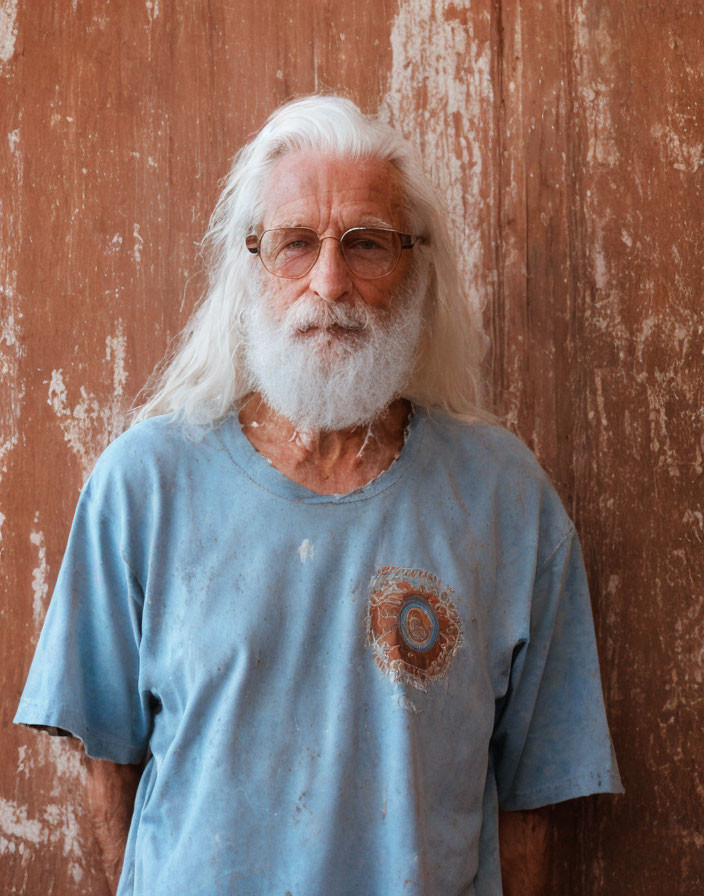 Elderly Man with Long White Hair and Beard Standing by Worn Brown Door