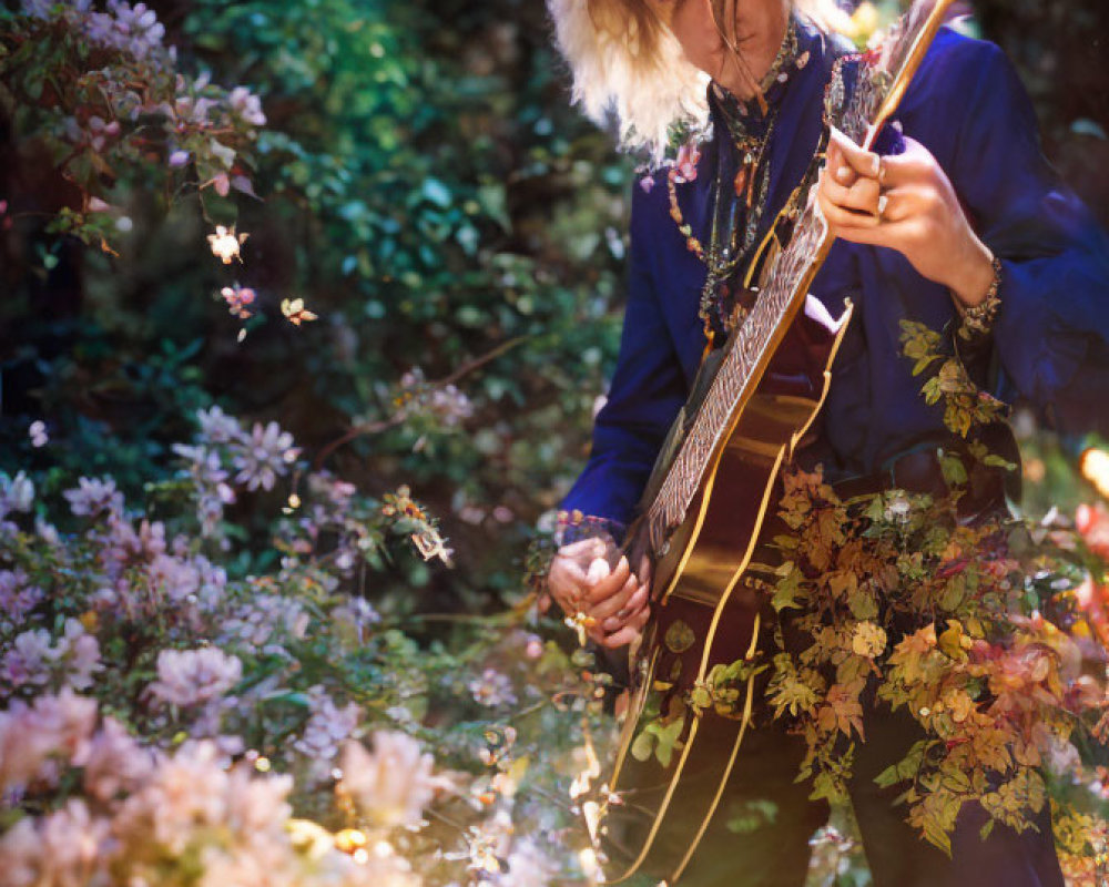 Blonde person playing guitar in blooming flower field