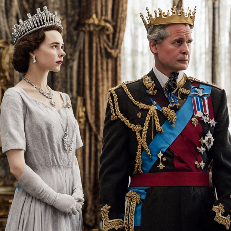 Regal man and woman in crown and tiara, adorned with medals and sashes, standing in