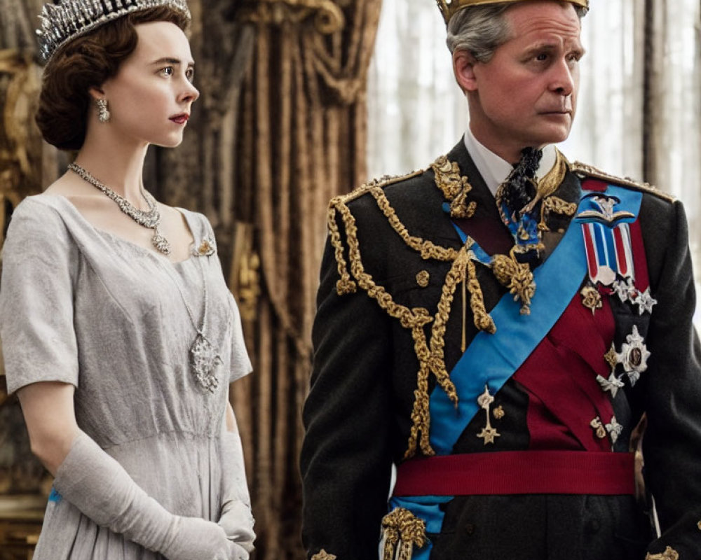 Regal man and woman in crown and tiara, adorned with medals and sashes, standing in