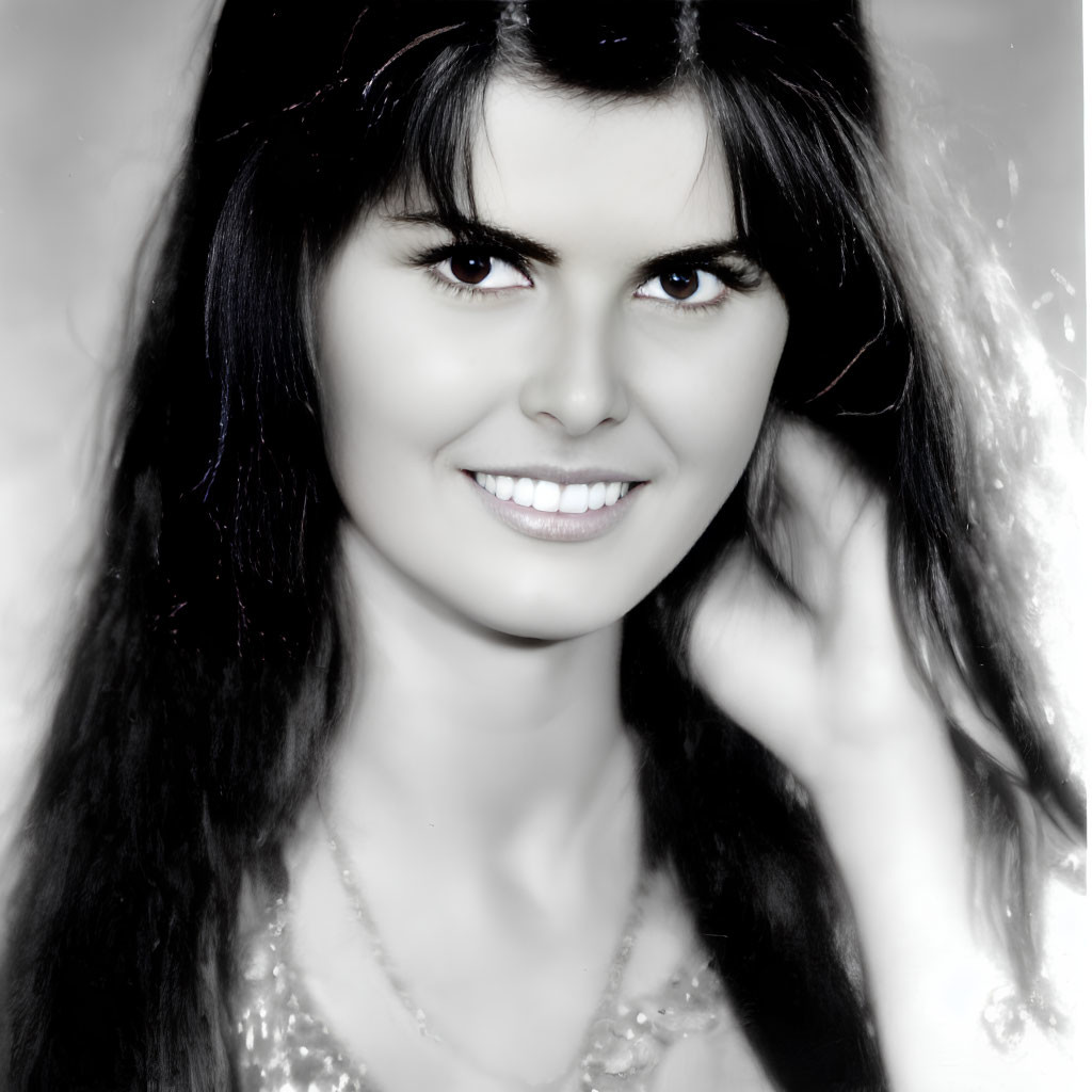 Smiling woman with voluminous hair in vintage black and white portrait