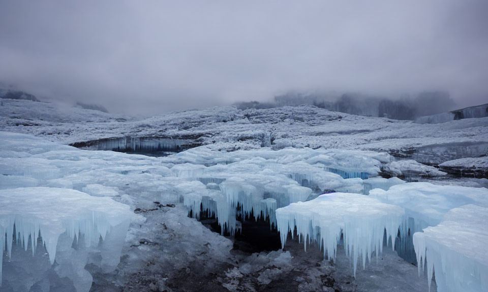 Icy landscape with jagged ice formations and misty mountains under a somber sky